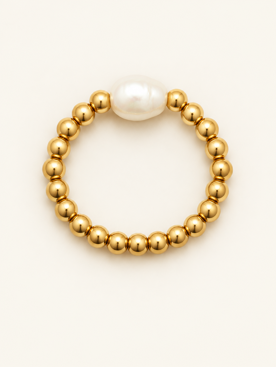 Gold bead ring with a baroque pearl on a neutral background