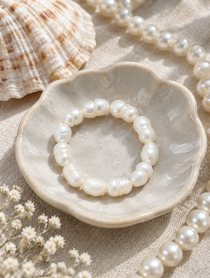 White baroque freshwater pearl beaded ring in a small dish with styling props