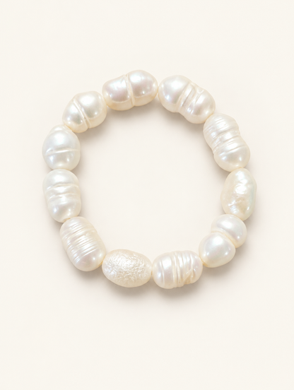 White baroque freshwater pearl beaded ring on a neutral background