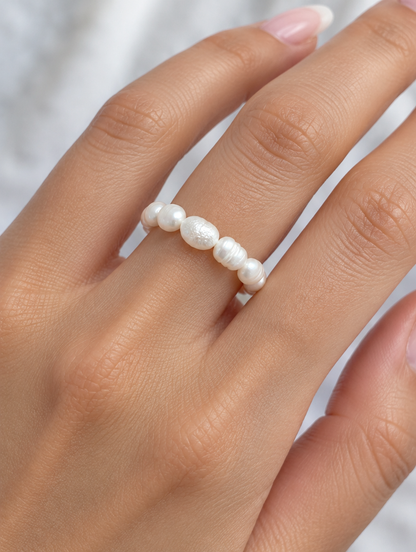 Woman wearing a white baroque freshwater pearl beaded ring on her finger