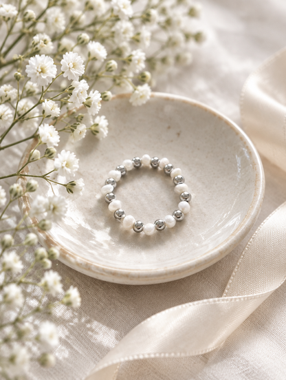 Silver mini bead ring with pearl accents in a small dish with styling props