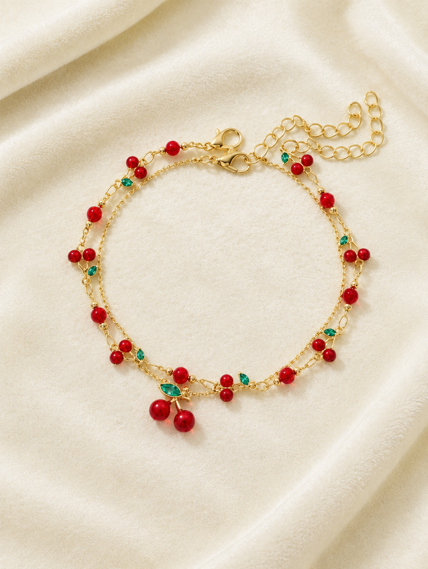 Gold red cherry bracelet on cream velvet