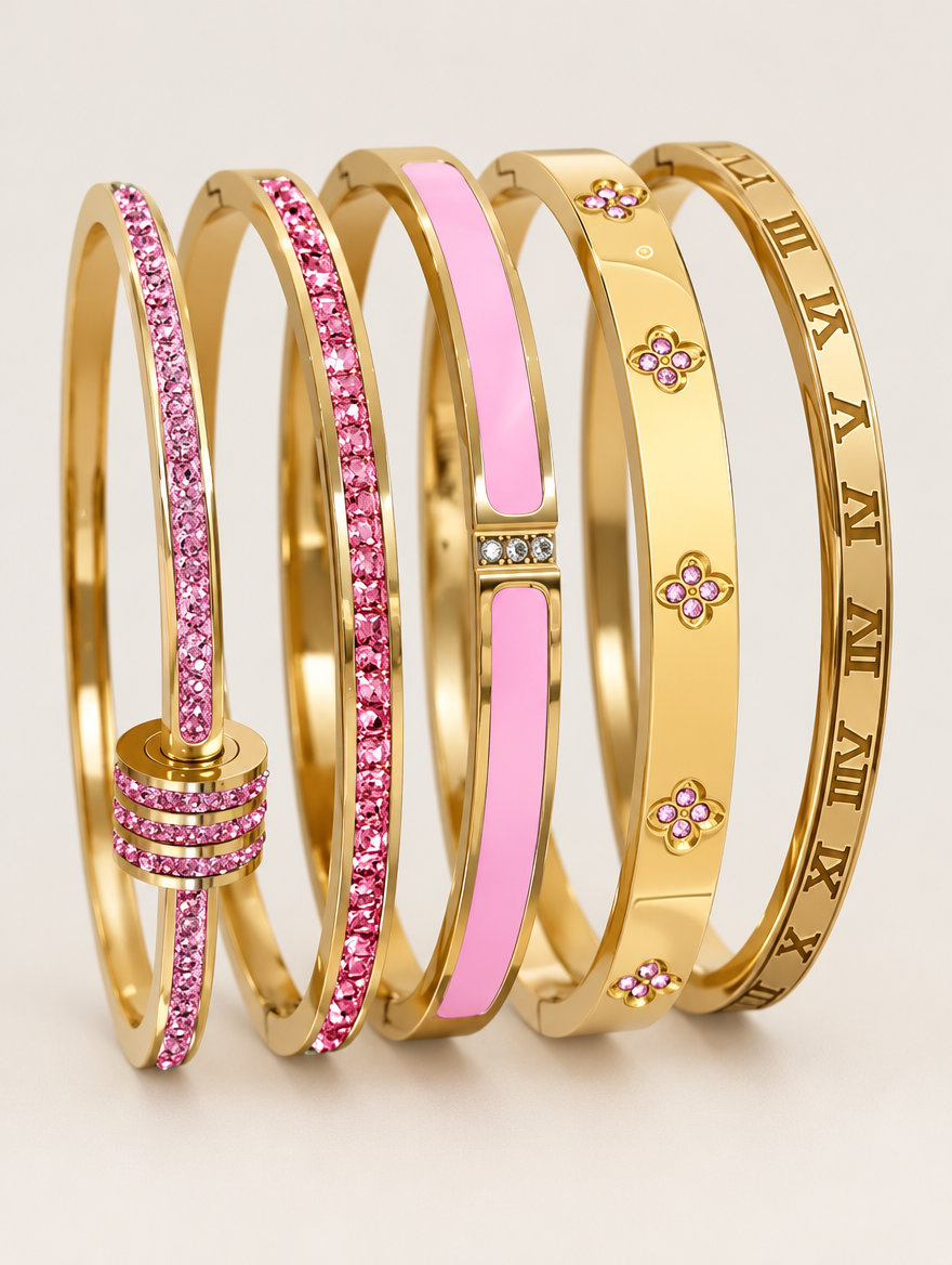 Set of five pink and gold stackable bangle bracelets on a neutral background