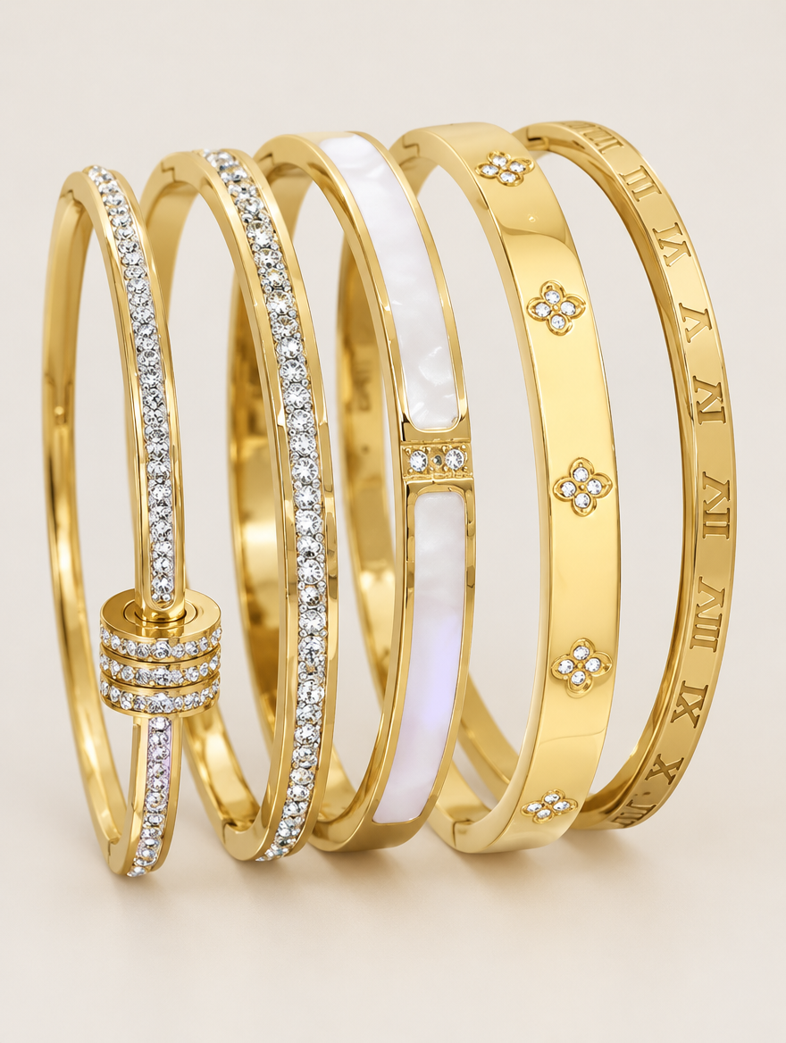 Set of five gold stackable bangle bracelets on a neutral background