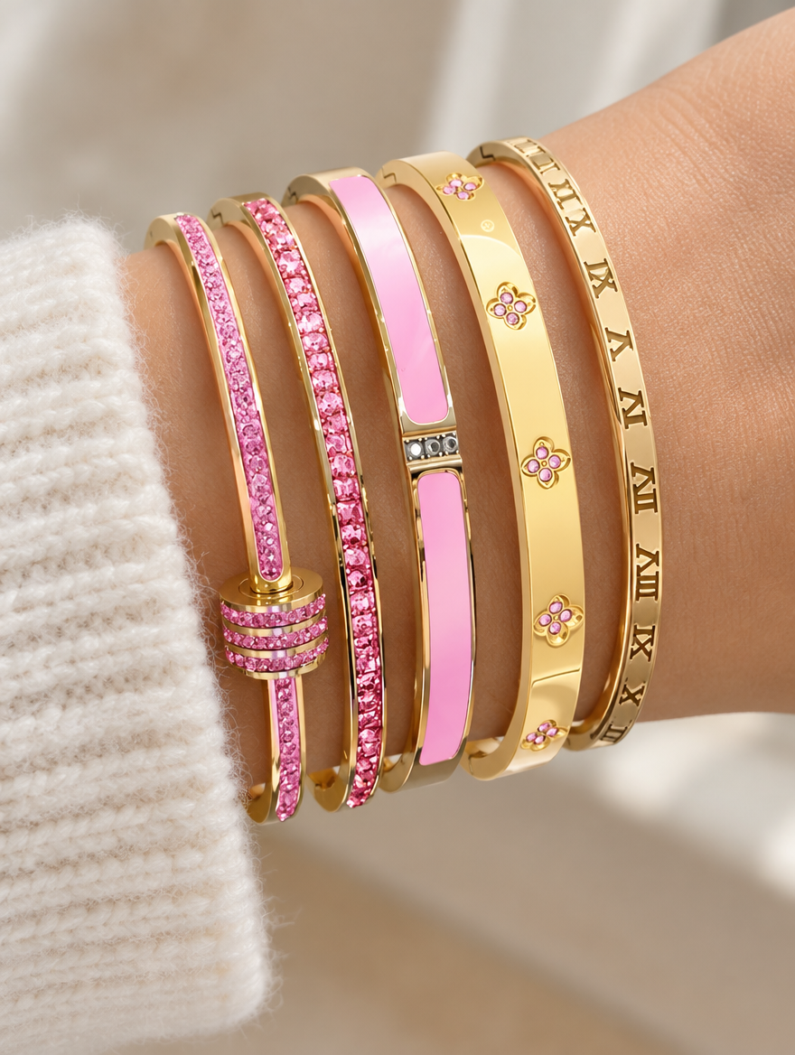 Woman wearing a stack of five pink and gold bangles
