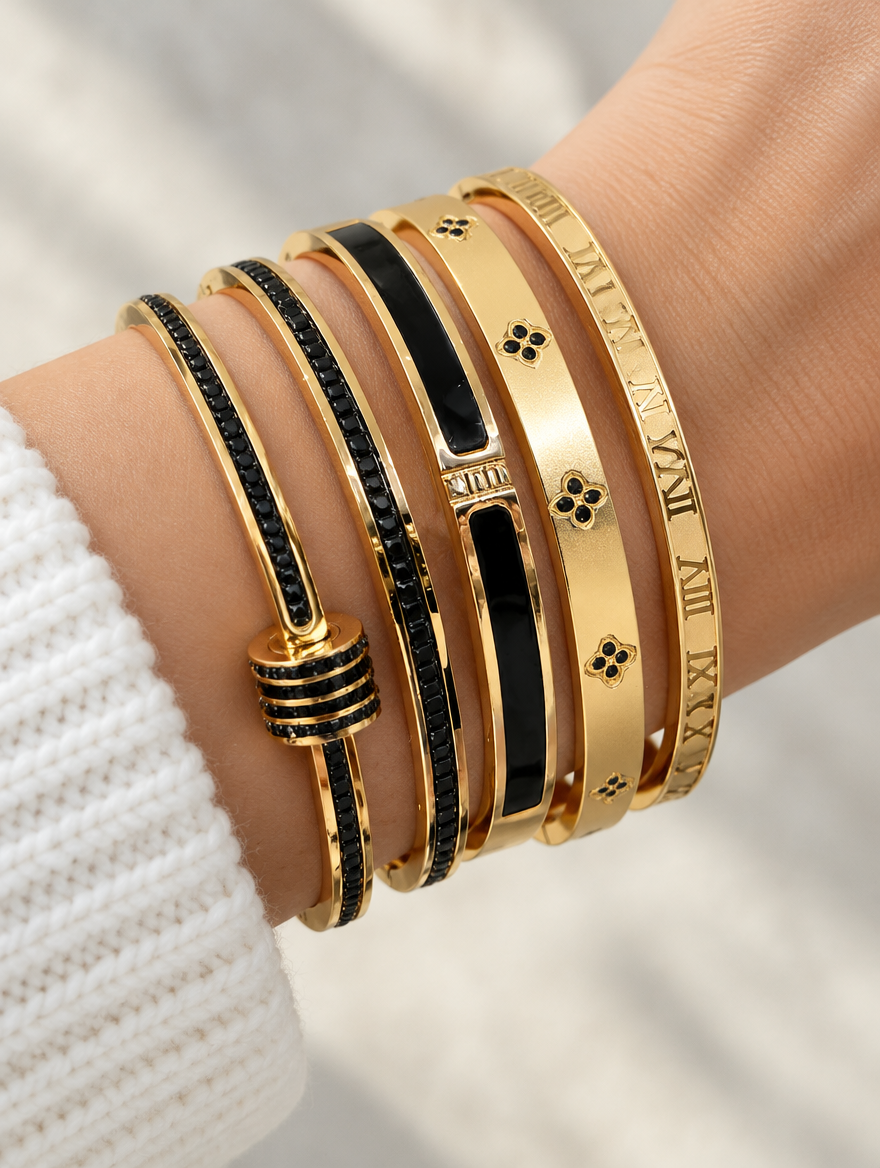 Woman wearing a stack of black and gold bangles