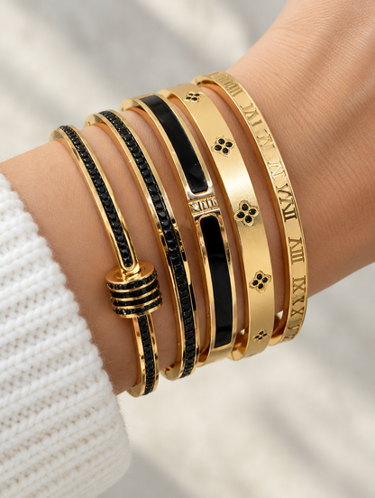 Woman wearing a stack of black and gold bangles
