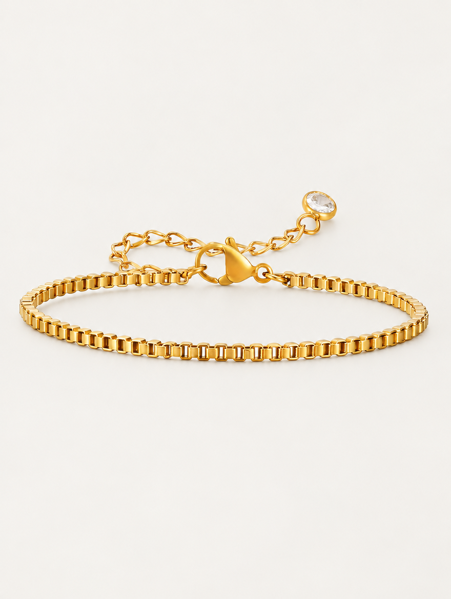Gold box chain bracelet on a neutral background