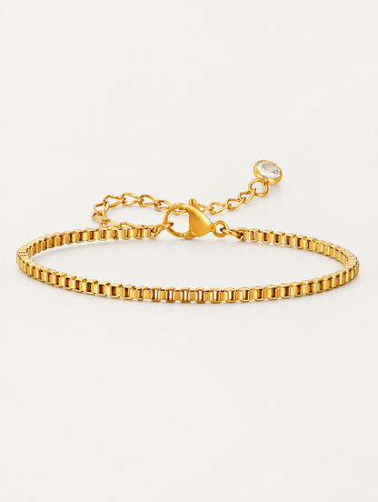 Gold box chain bracelet on a neutral background