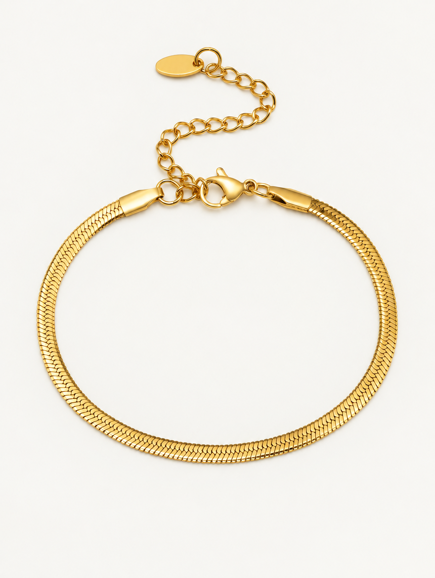Gold herringbone chain bracelet on a neutral background