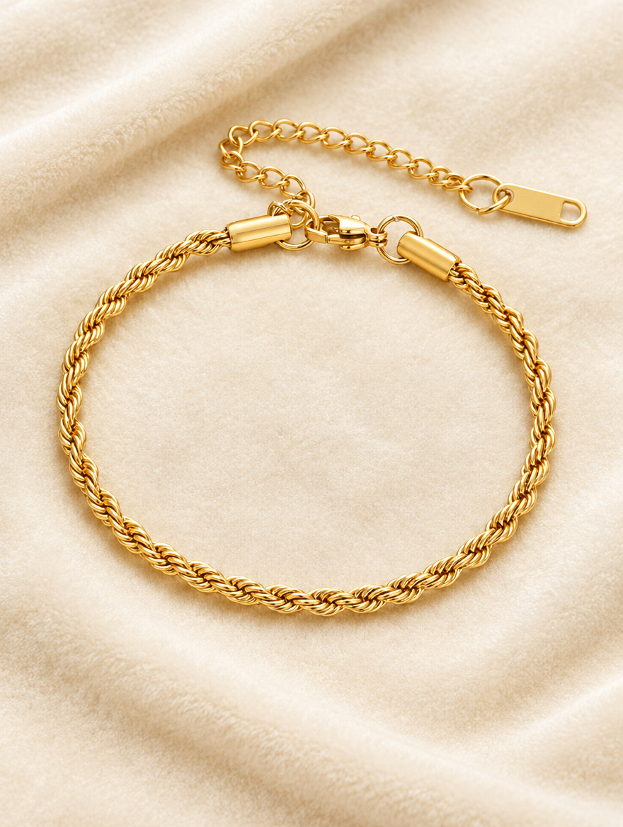 Gold rope chain bracelet on cream velvet