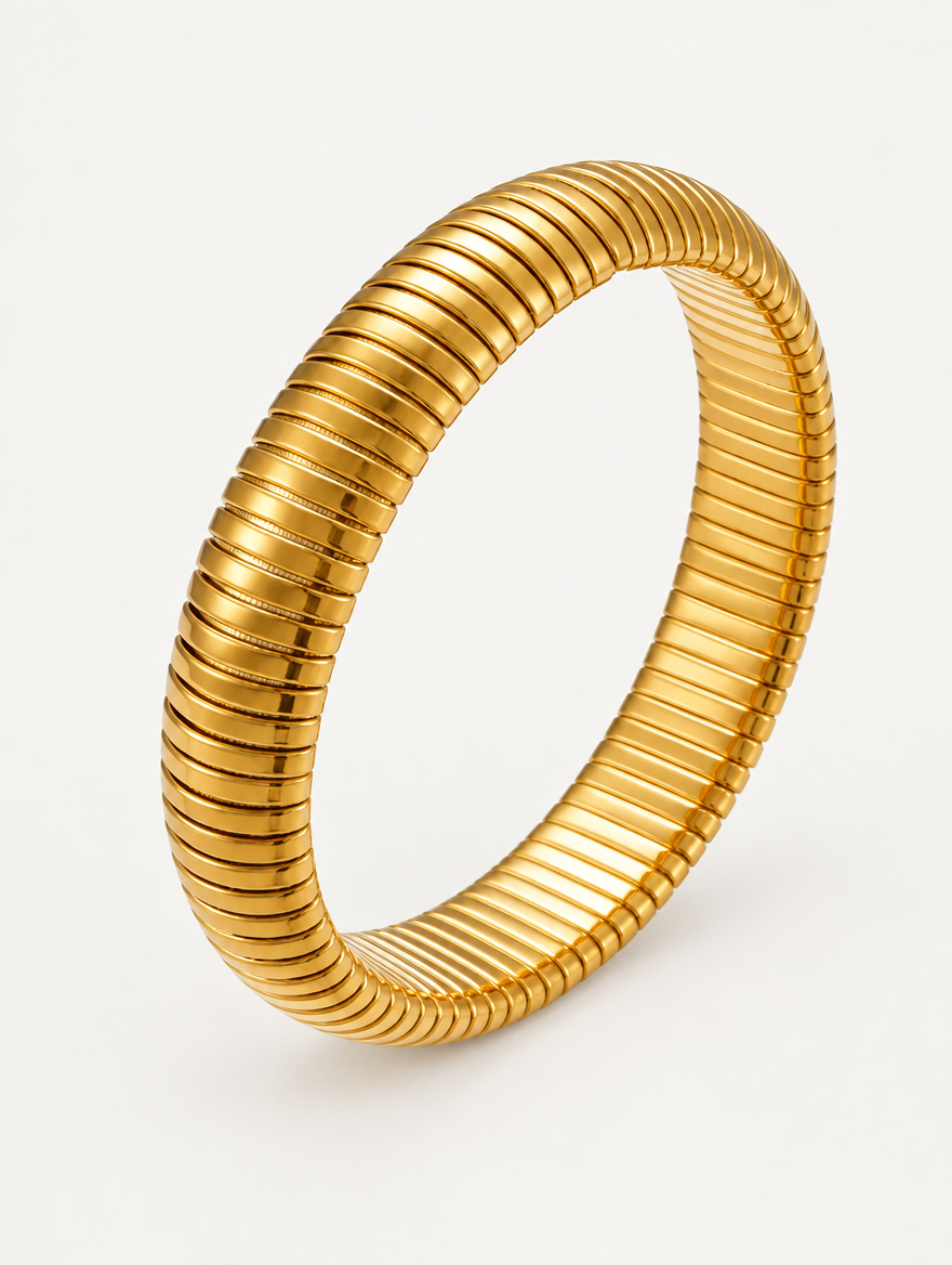 Gold wide ribbed stretch bracelet on a neutral background