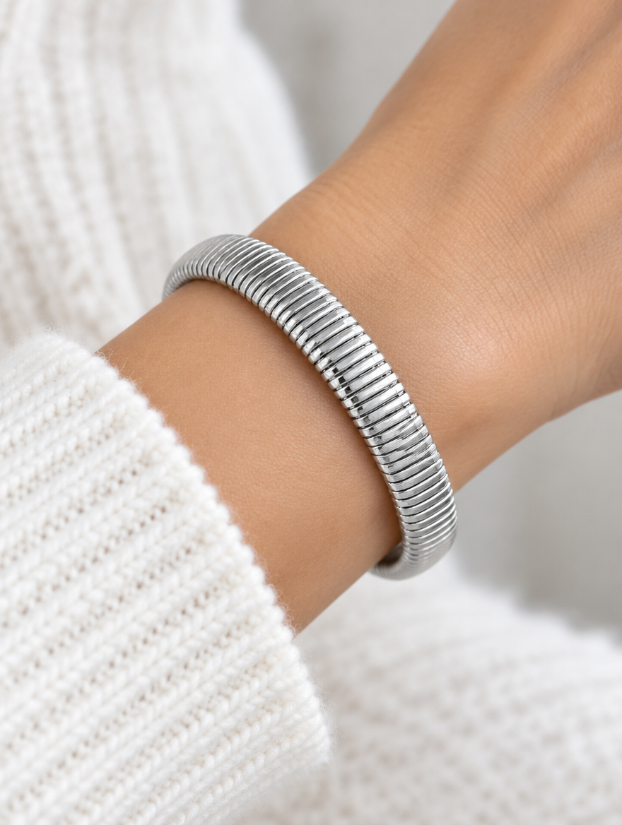 Woman wearing a silver wide ribbed stretch bracelet