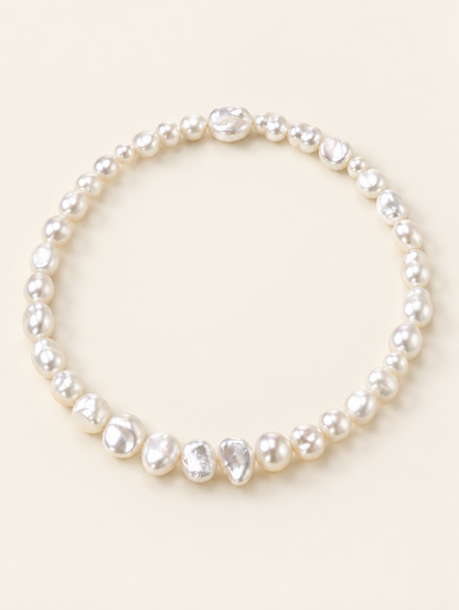 White baroque freshwater pearl choker necklace on a neutral background