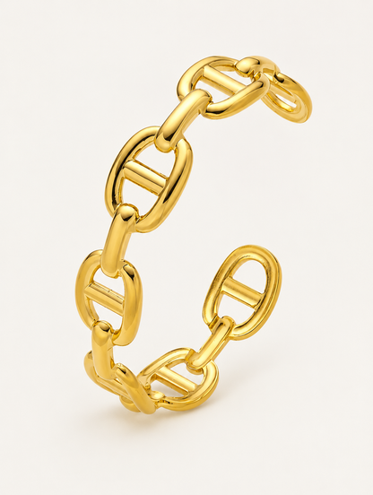 Gold open cuff bangle with mariner links on a neutral background