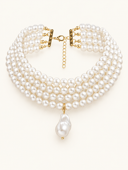 Gold-tone layered pearl collar choker with a baroque pearl drop on a neutral background