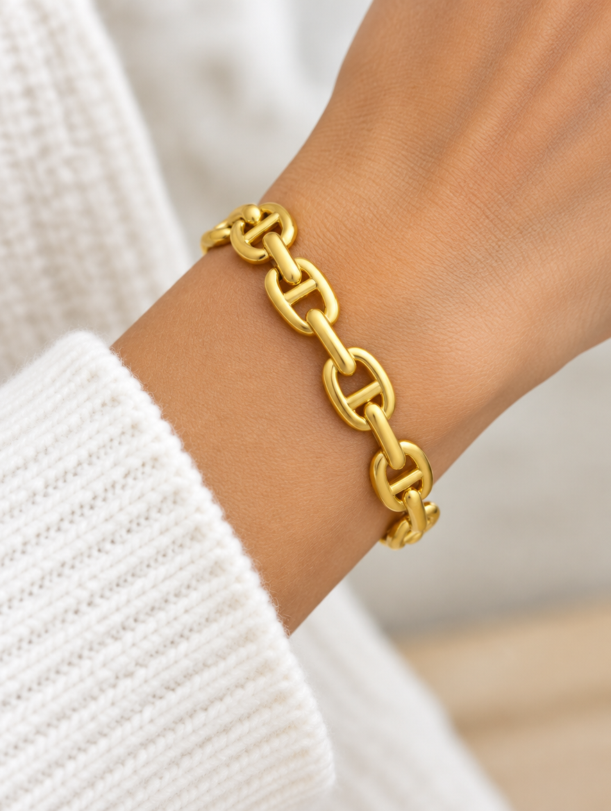 Woman wearing a gold mariner link open cuff bangle