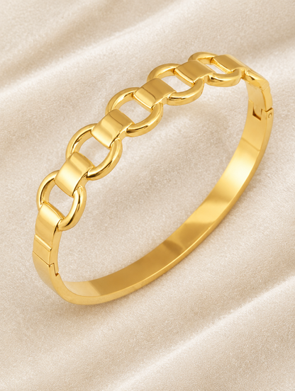 Gold hinged mariner link bangle on cream velvet