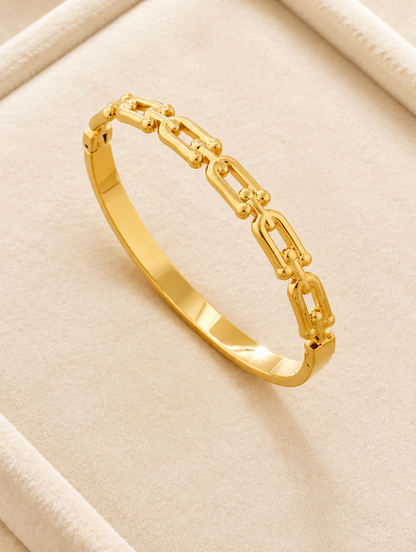 Gold hinged link bangle on cream velvet