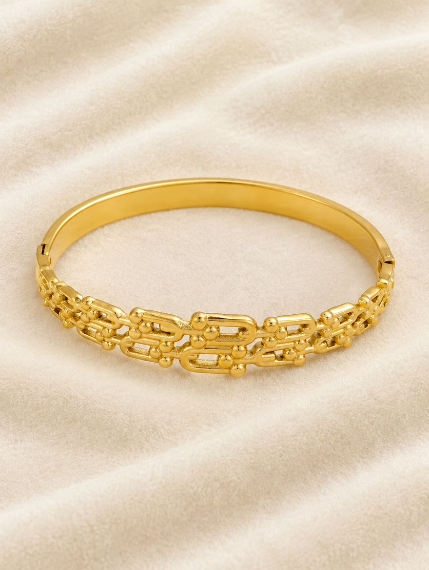 Gold openwork bangle on cream velvet