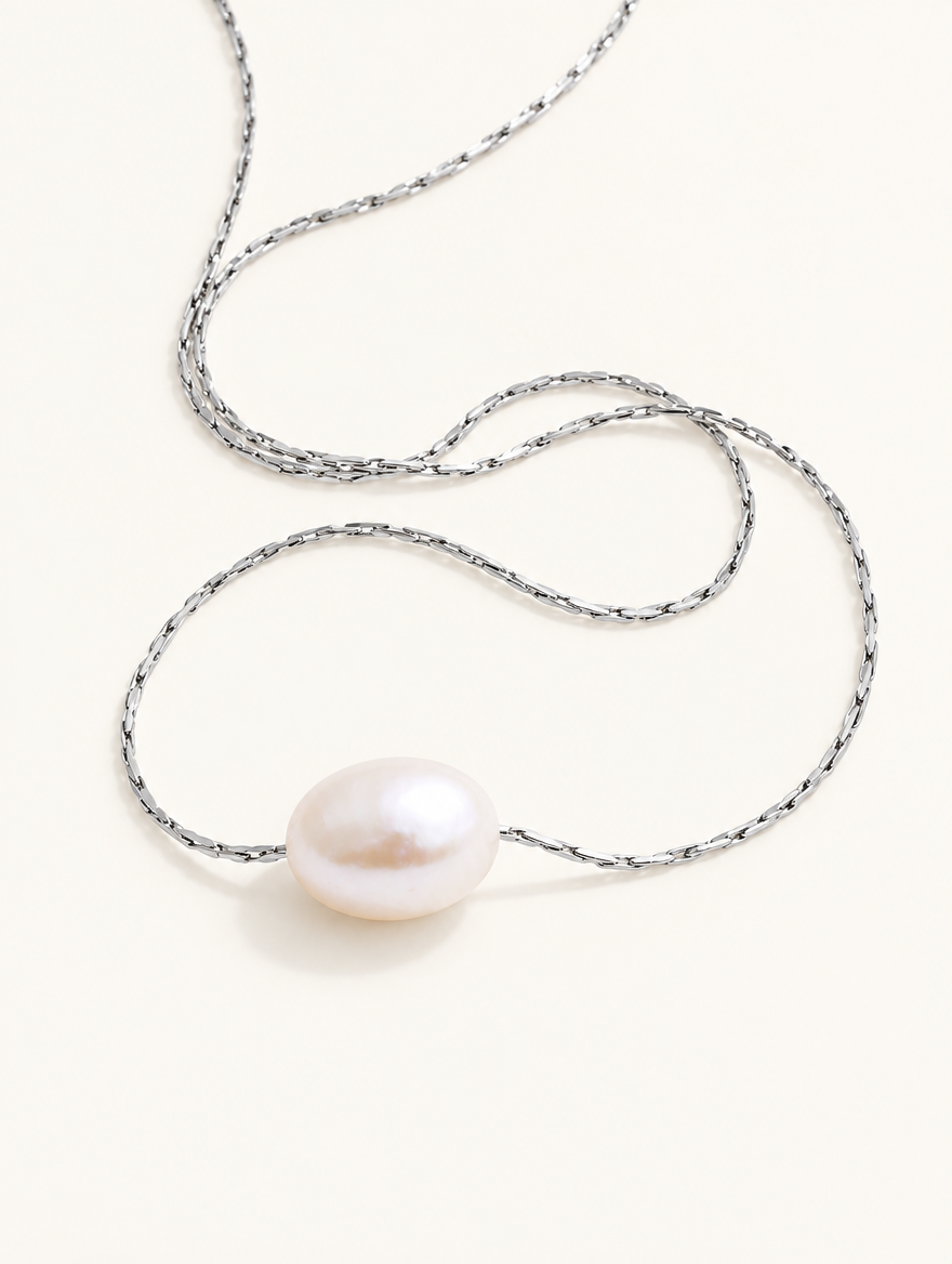 Silver-tone chain necklace with a single freshwater pearl pendant on a neutral background