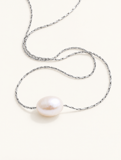 Silver-tone chain necklace with a single freshwater pearl pendant on a neutral background