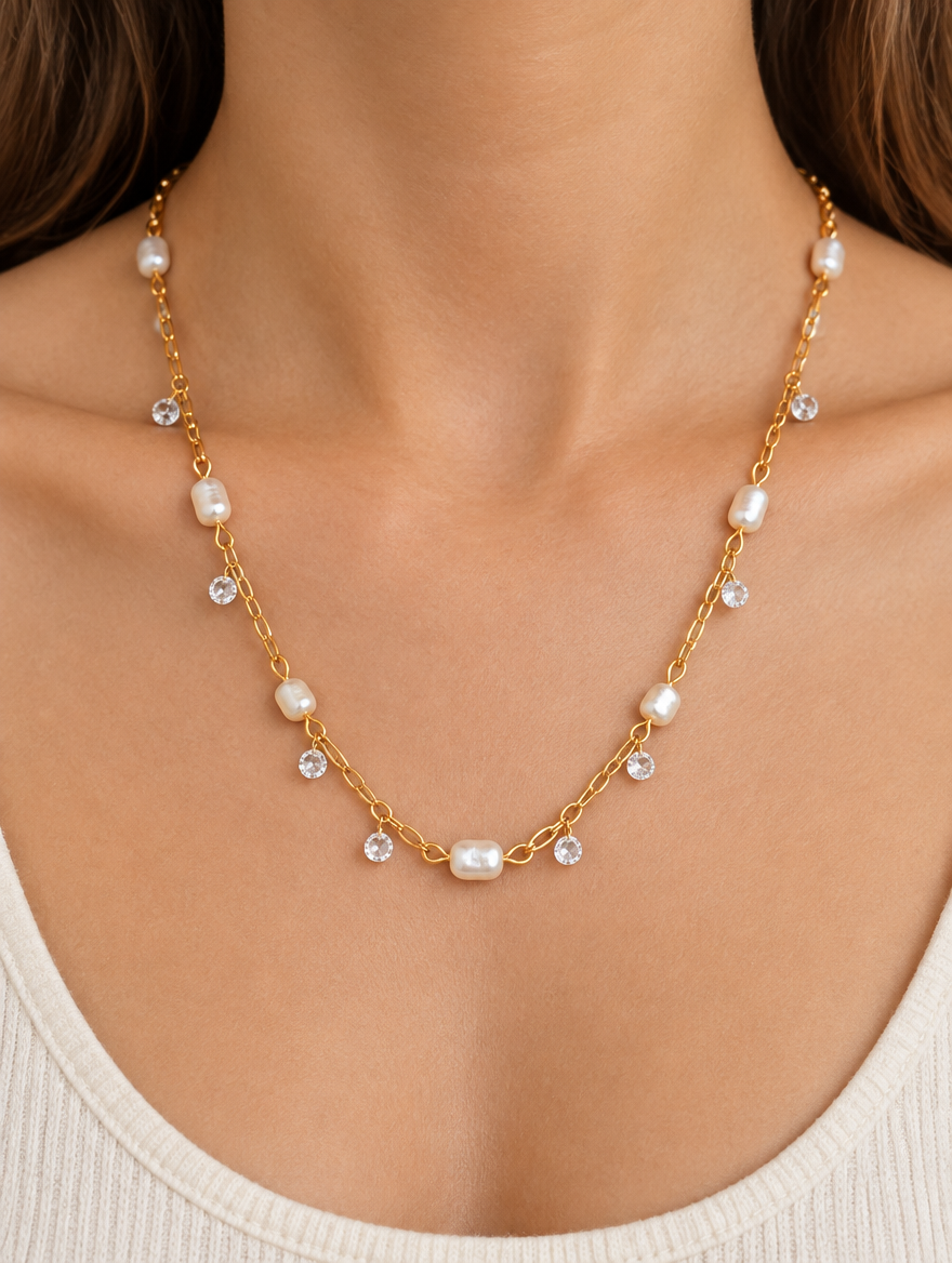 Woman wearing a gold-tone necklace with small pearls and zirconia accents