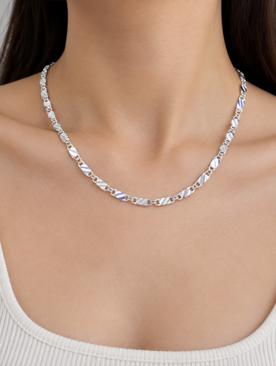 Woman wearing a silver-tone flat link side chain necklace