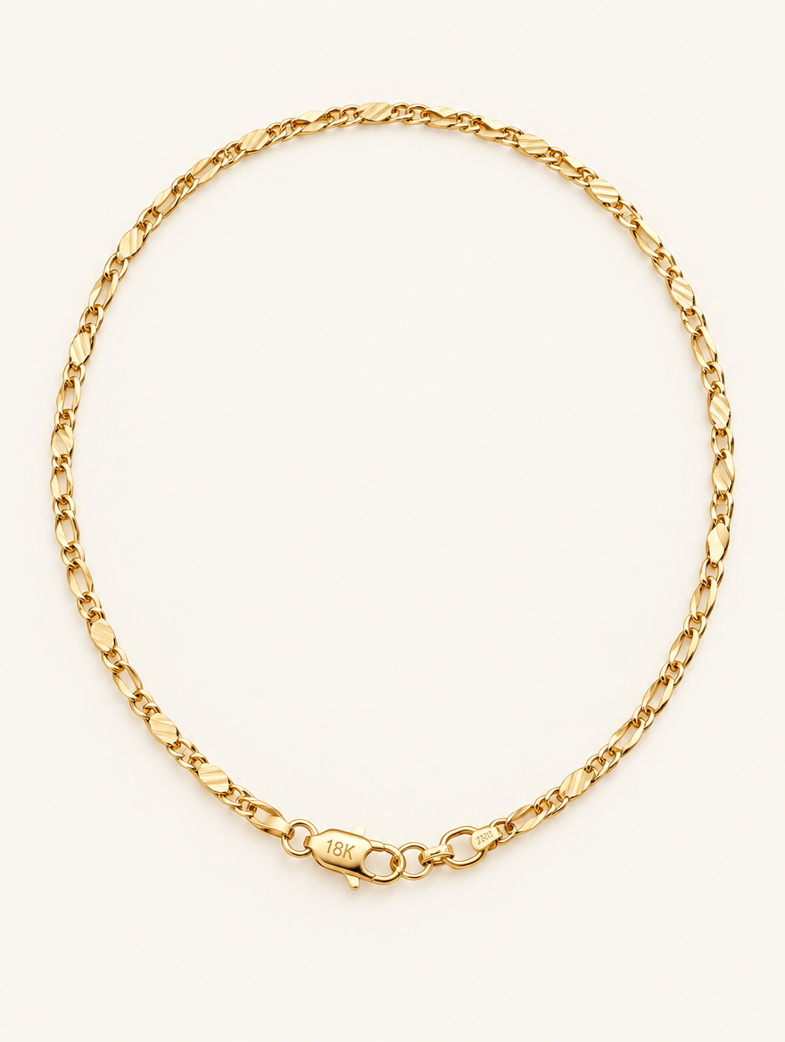 Gold-tone 2 mm flat link side chain necklace on a neutral background