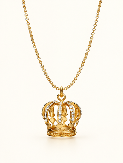 Gold crown pendant necklace with crystals on a neutral background