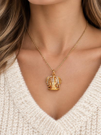 Woman wearing a gold crown pendant necklace with crystals