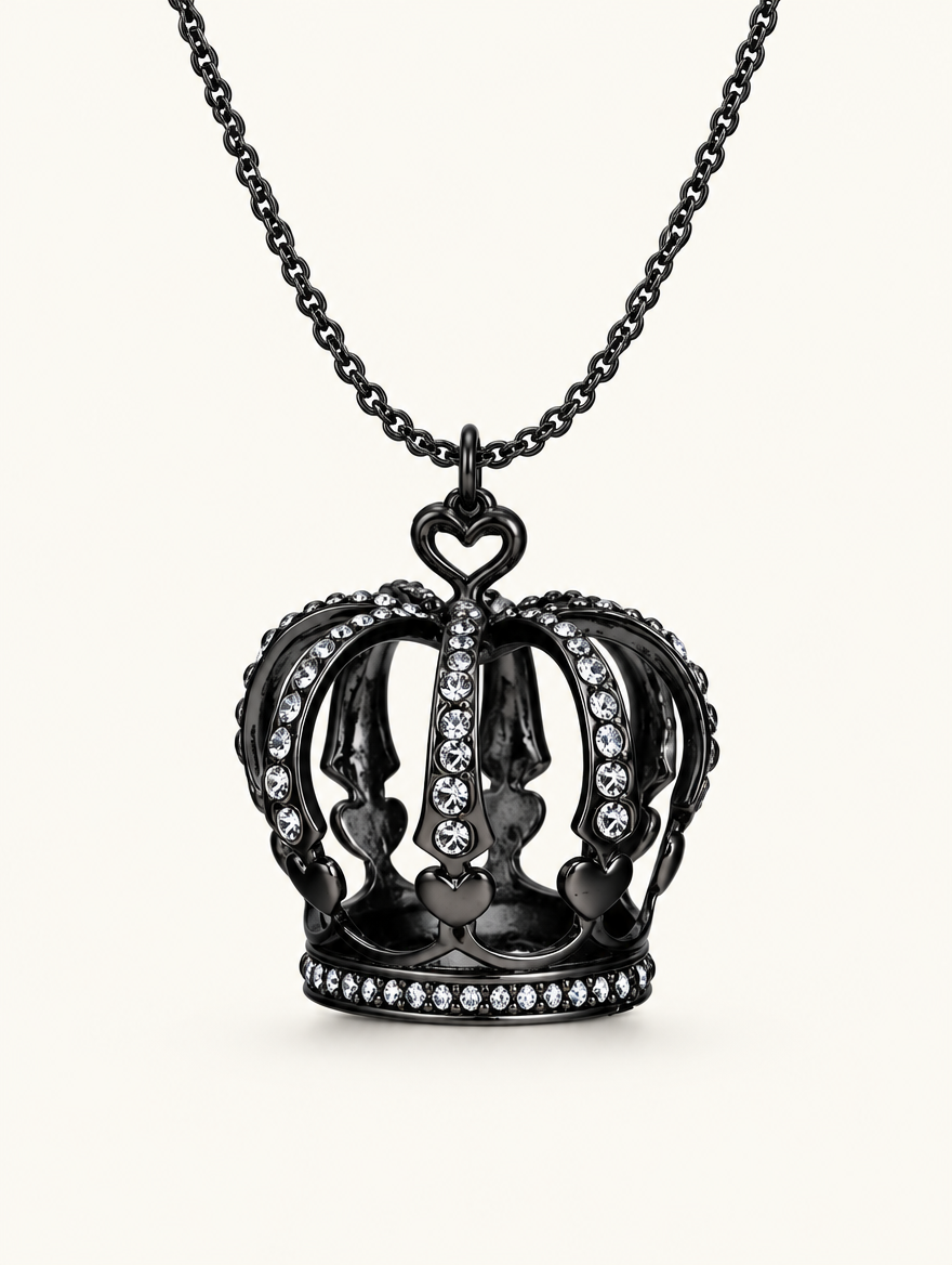 Black crown pendant necklace with crystals on a neutral background