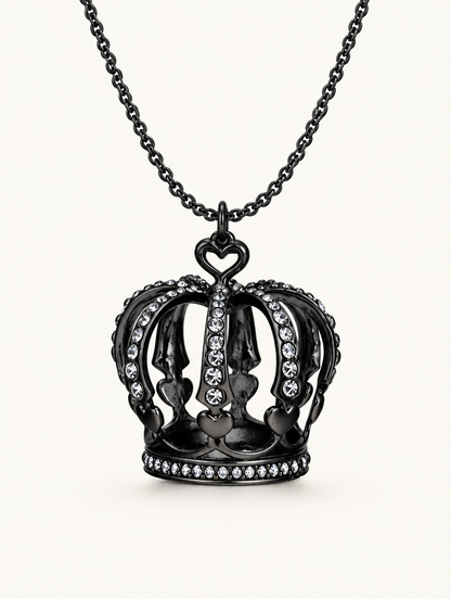 Black crown pendant necklace with crystals on a neutral background