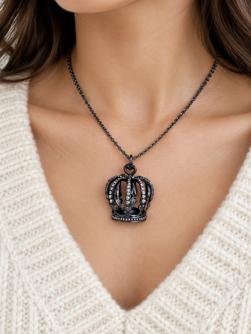 Woman wearing a black crown pendant necklace with crystals