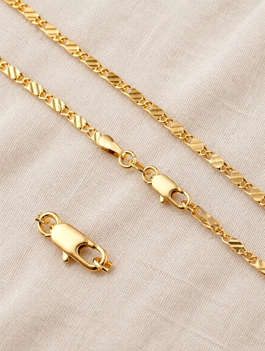 Gold side chain necklace lying on linen