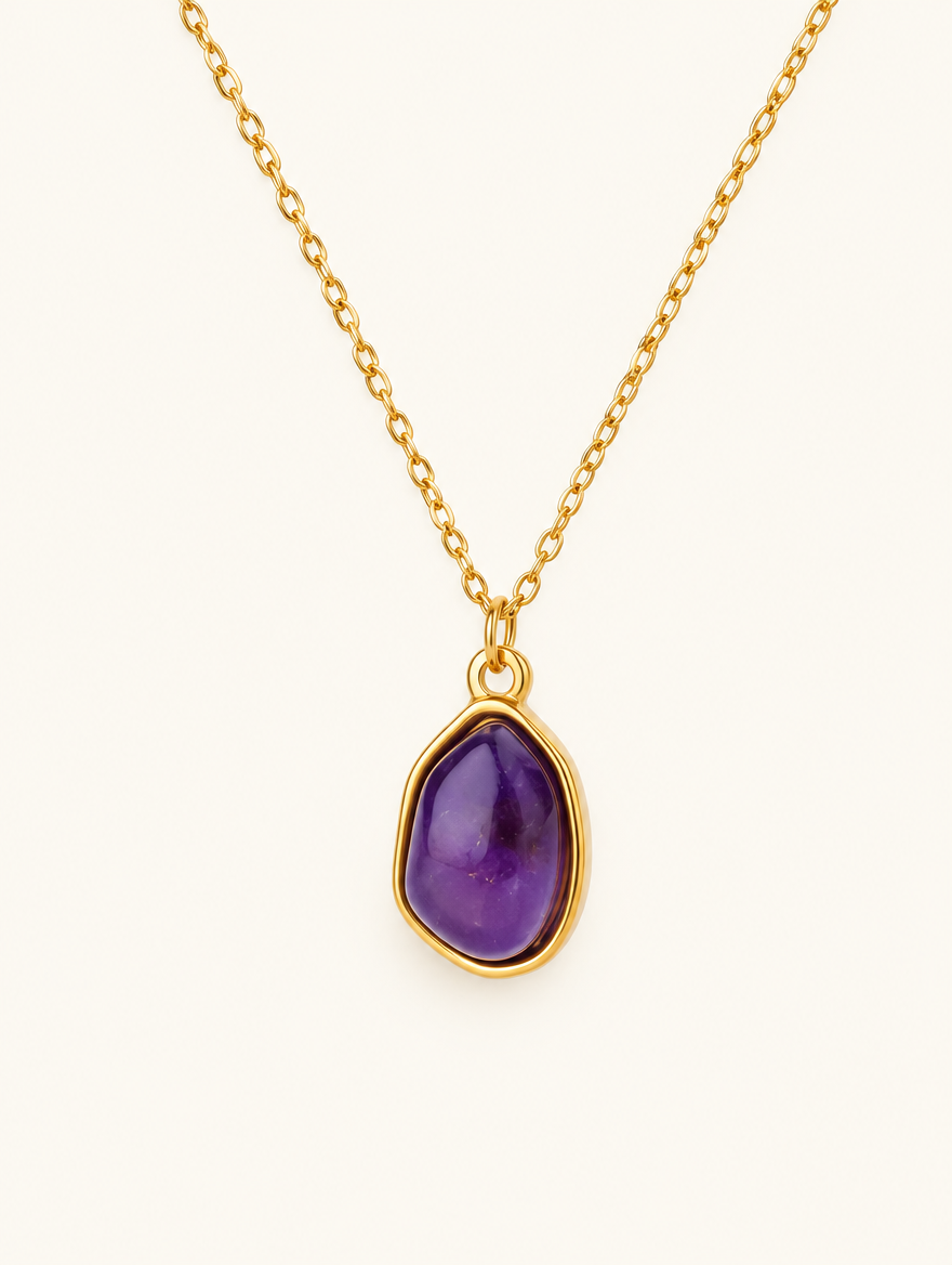 Gold-tone chain necklace with a purple oval stone pendant on a neutral background