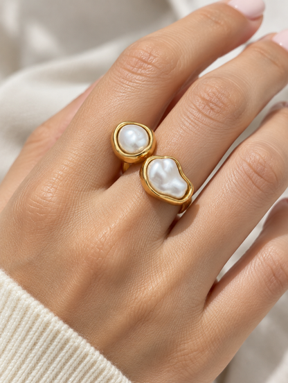 Woman wearing a gold double baroque pearl ring on her finger