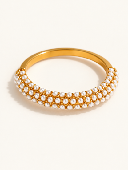 Gold pearl pavé band ring on a neutral background