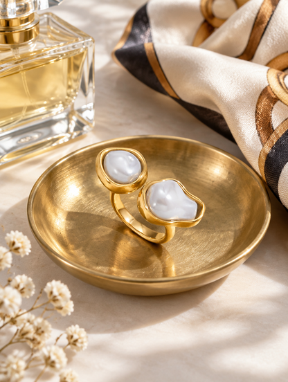 Gold double baroque pearl ring in a small dish with styling props
