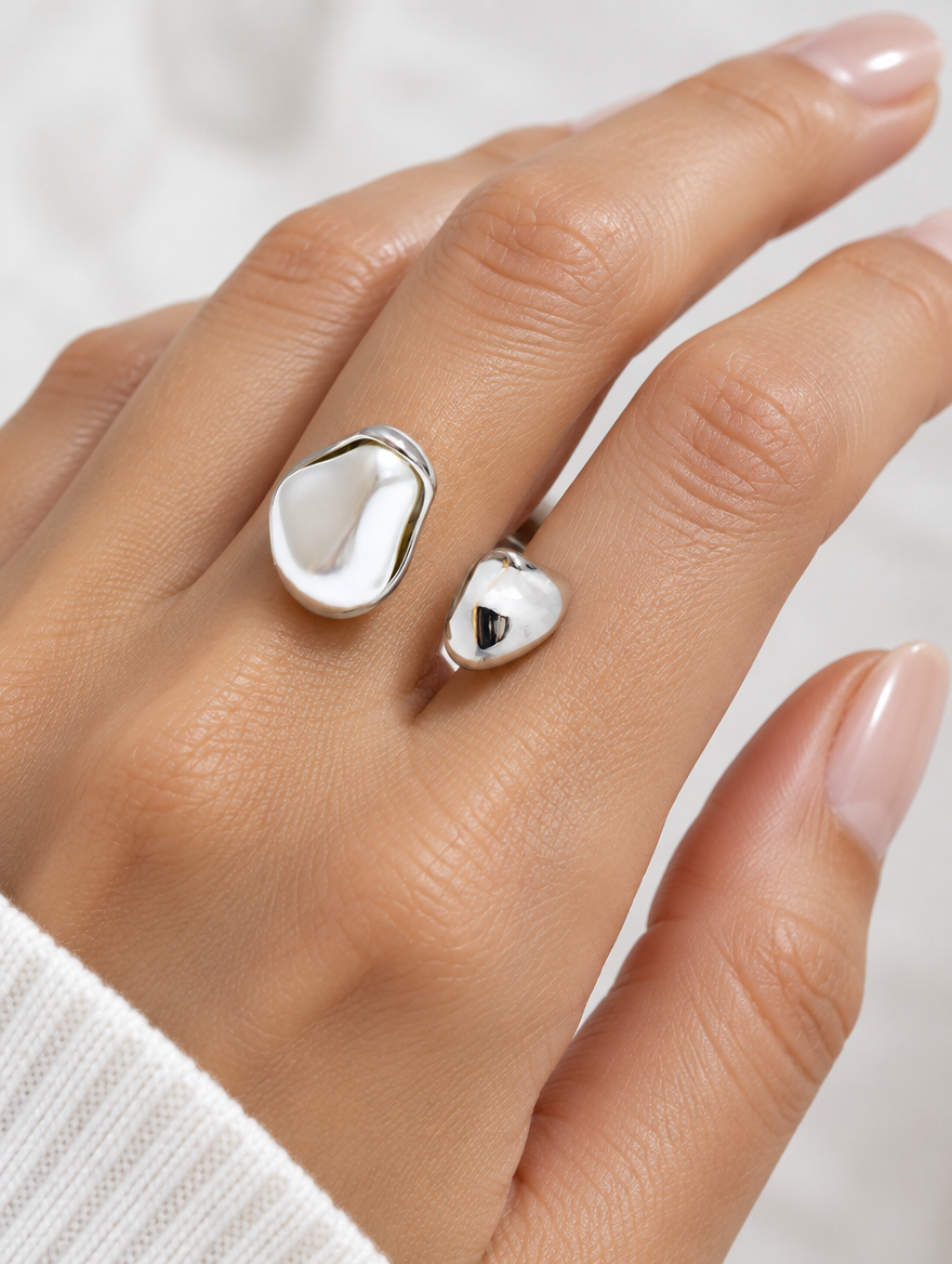 Woman wearing a silver baroque pearl teardrop ring on her finger
