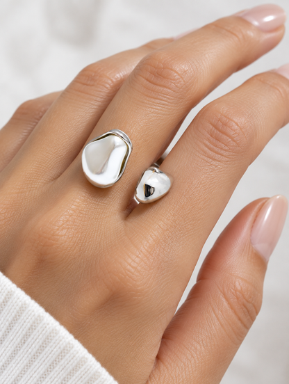 Woman wearing a silver baroque pearl teardrop ring on her finger