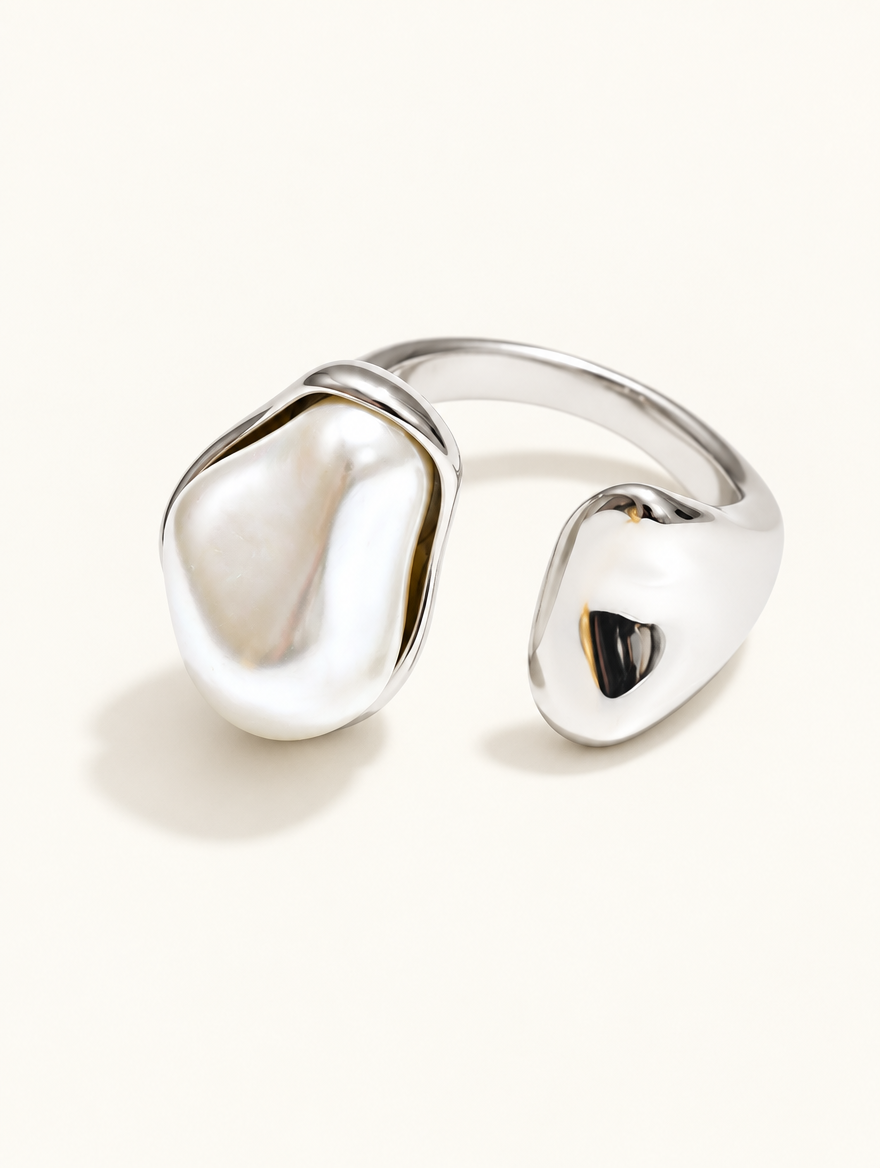 Silver baroque pearl teardrop ring on a neutral background