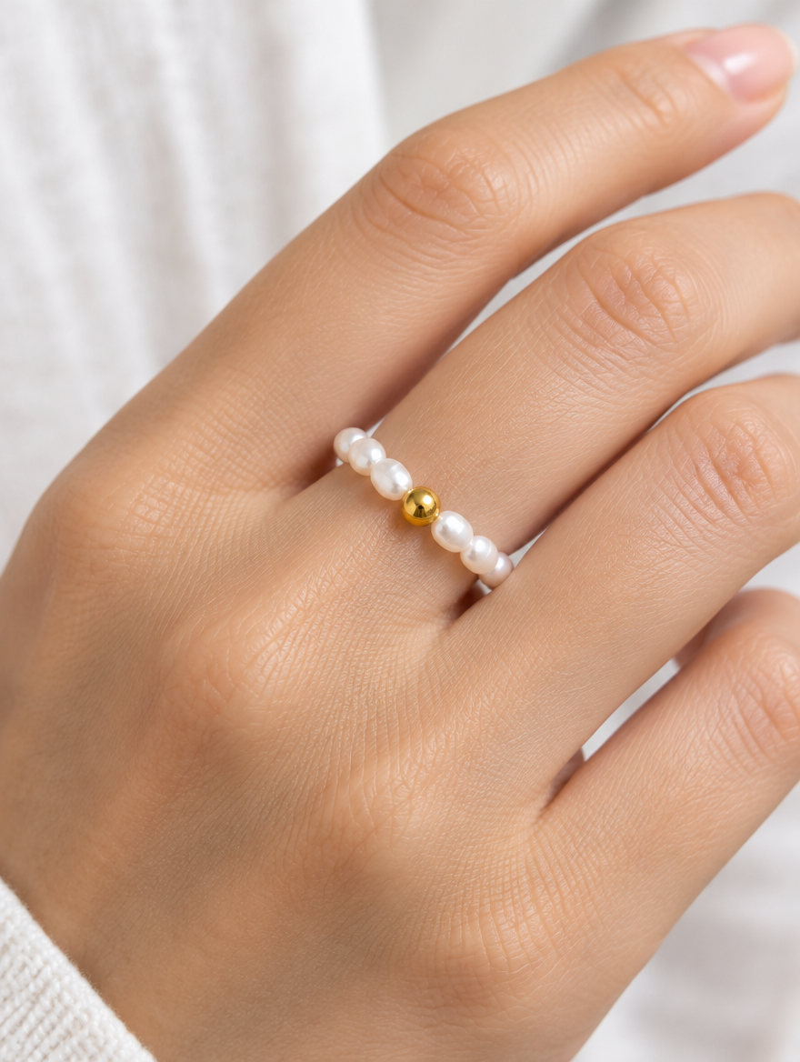 Woman wearing a freshwater pearl beaded stretch ring on her finger