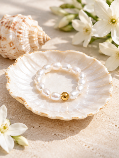 Freshwater pearl beaded stretch ring in a small dish with styling props