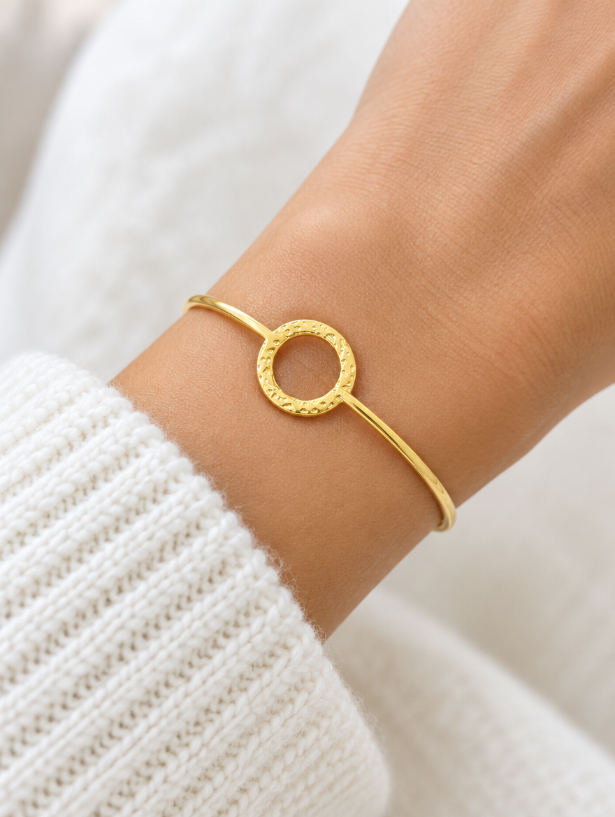 Woman wearing a gold circle open cuff bracelet