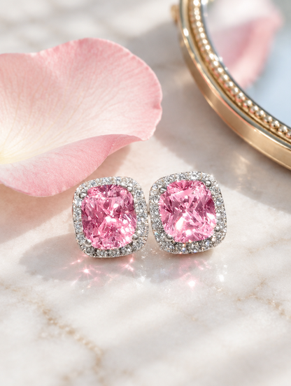 Pink halo cushion-cut cz stud earrings in a styled still life with props