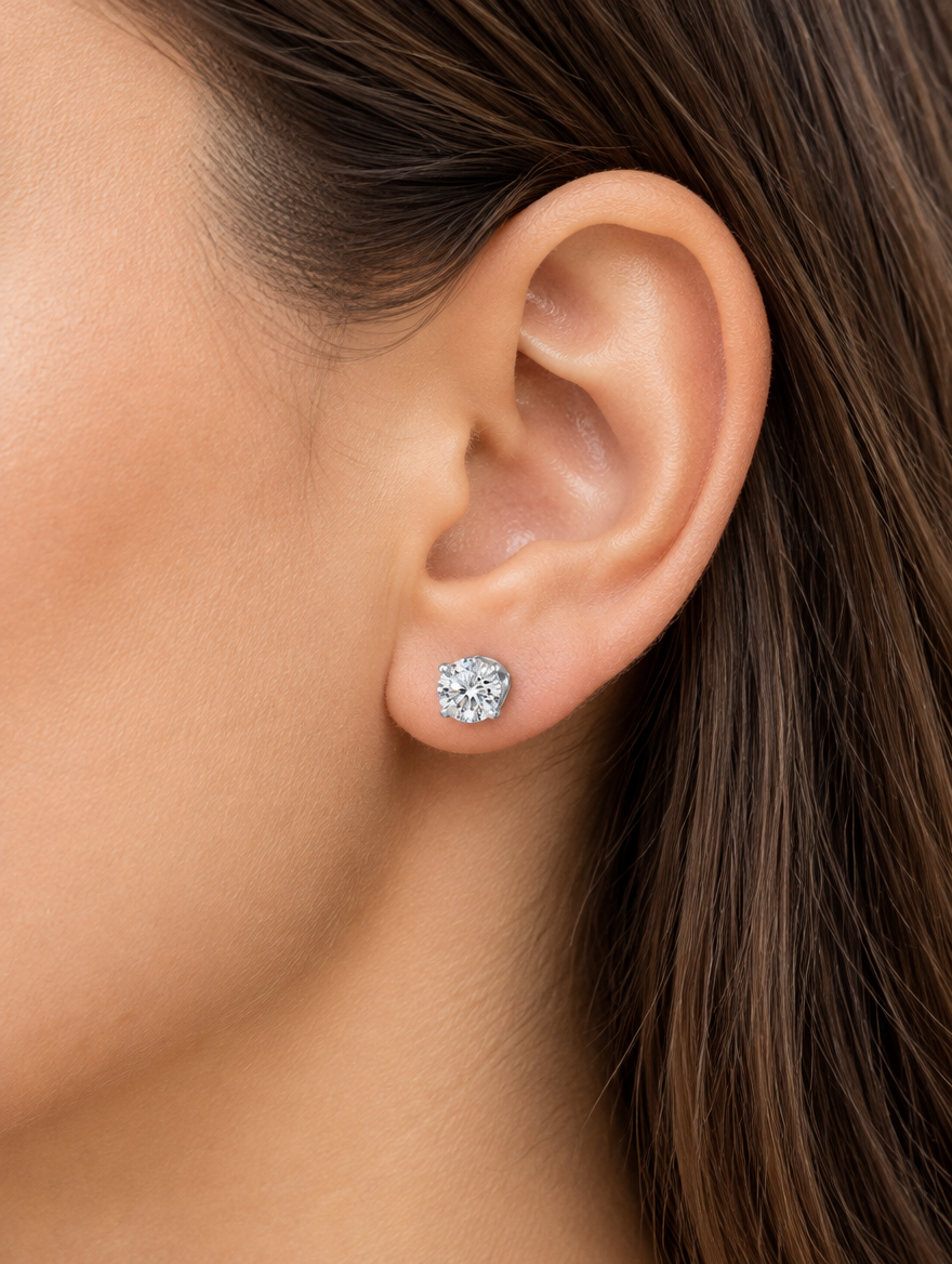 Woman wearing a silver claw-set cz stud earring