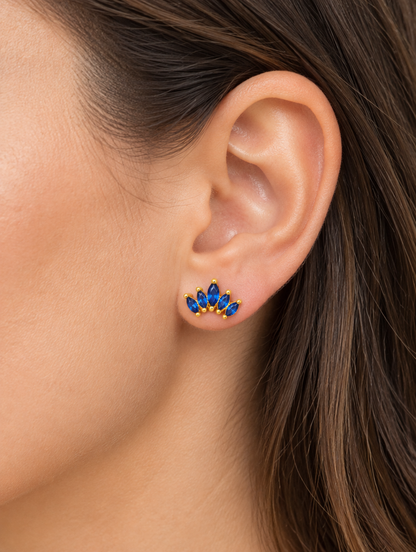 Woman wearing a gold blue marquise fan stud earring