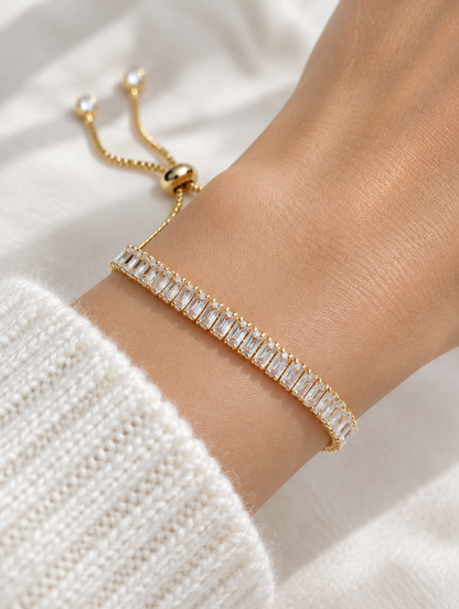 Woman wearing a gold baguette zircon tennis bracelet