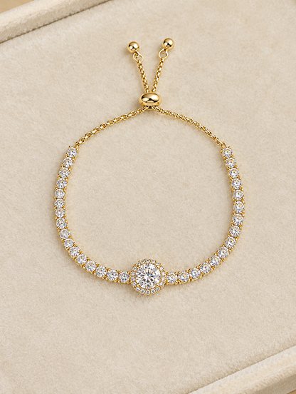 Gold round stone tennis bracelet on cream velvet